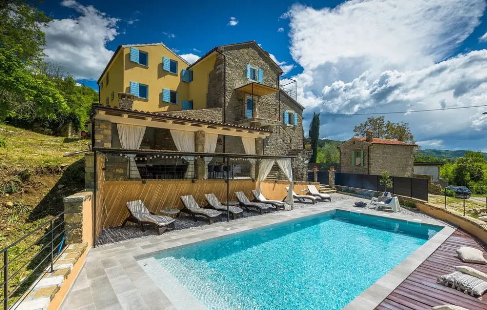 Countryside villa with a pool and sun loungers.