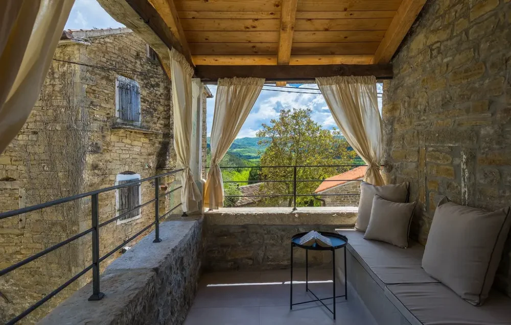 Cozy stone balcony with countryside view.