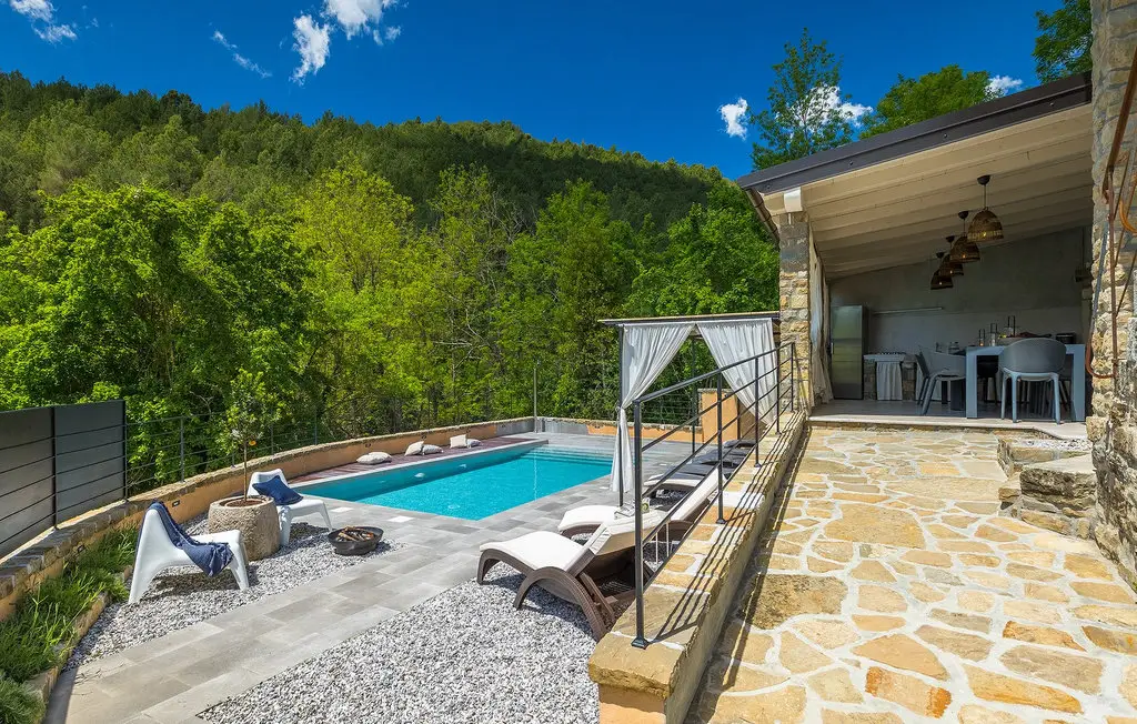Mountain retreat with pool and outdoor seating area.