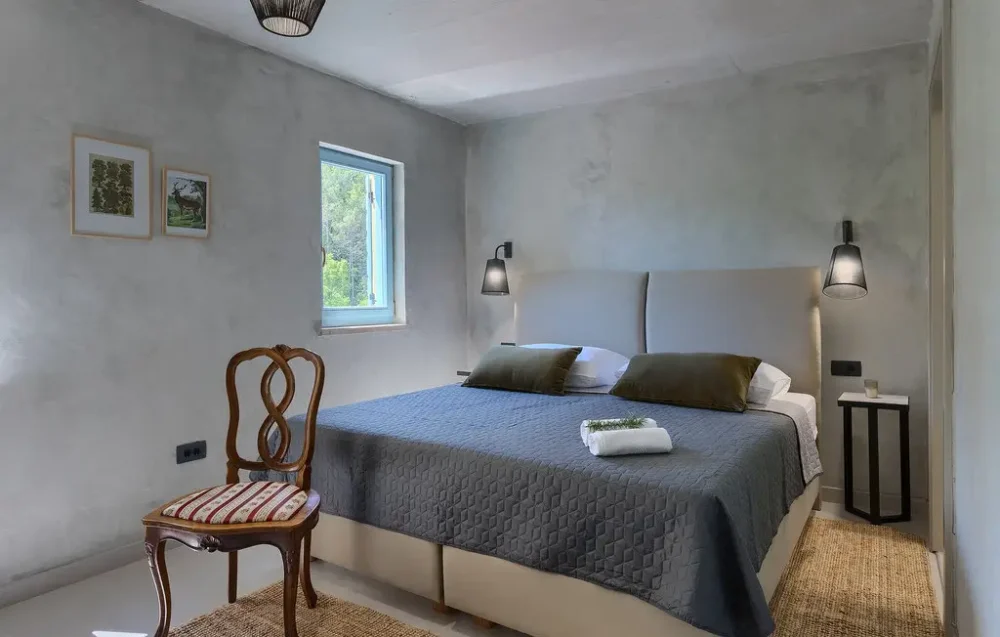 Cozy bedroom with large bed and natural light.