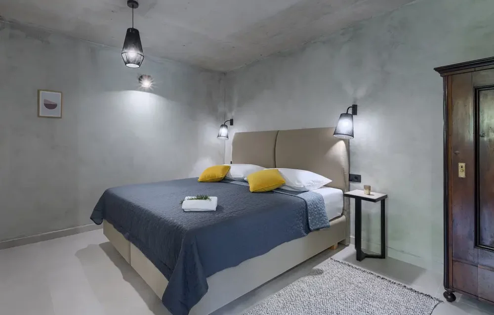 Modern bedroom with king-size bed and gray decor.