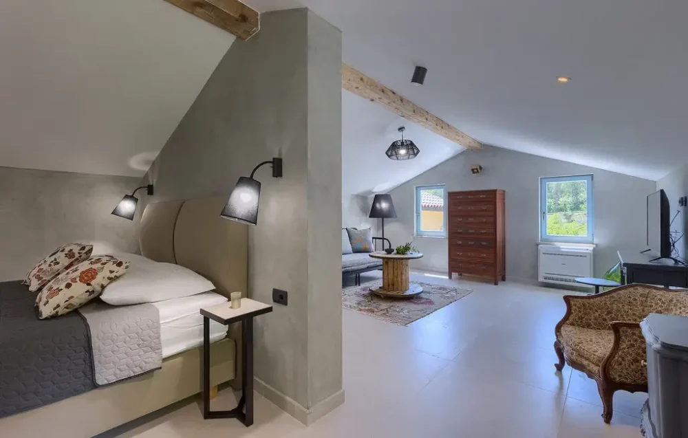 Spacious attic bedroom with modern decor and furniture.