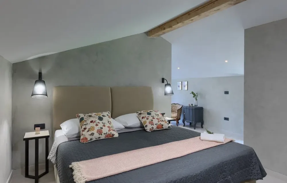 Cozy bedroom with modern decor and bedding.