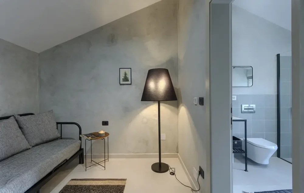 Modern living room with sofa and floor lamp.