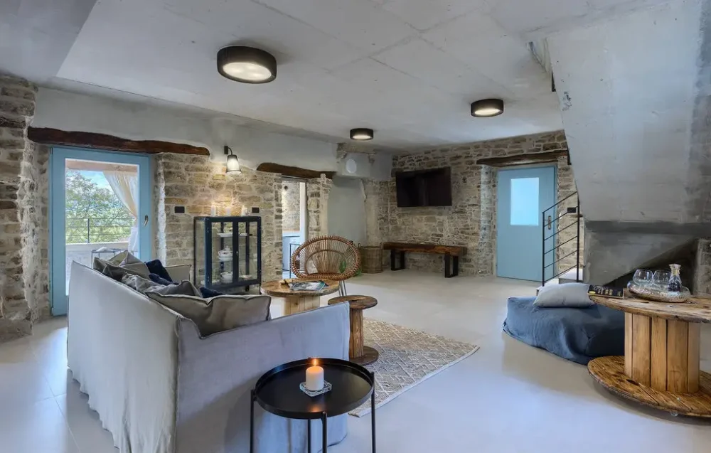Rustic living room with stone walls and modern decor.