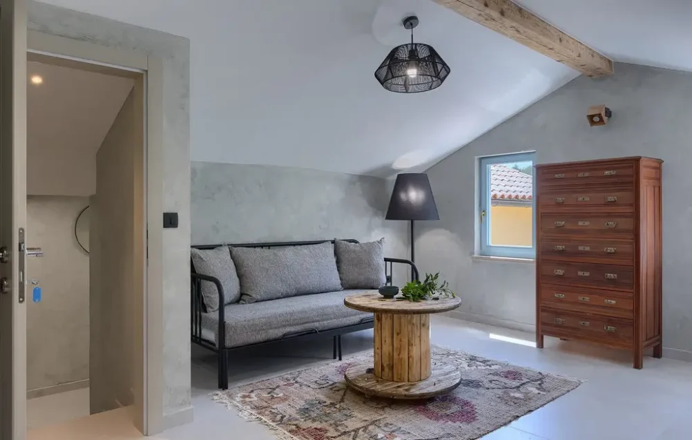 Modern attic room with sofa and table.