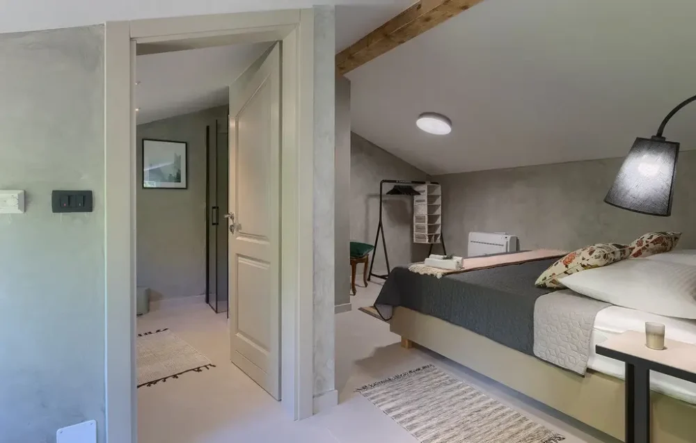 Modern bedroom with gray walls and cozy decor.
