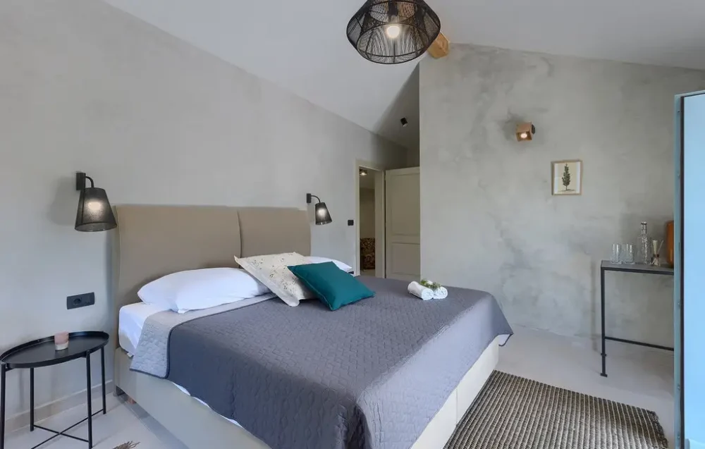 Modern bedroom with gray bedding and decor.