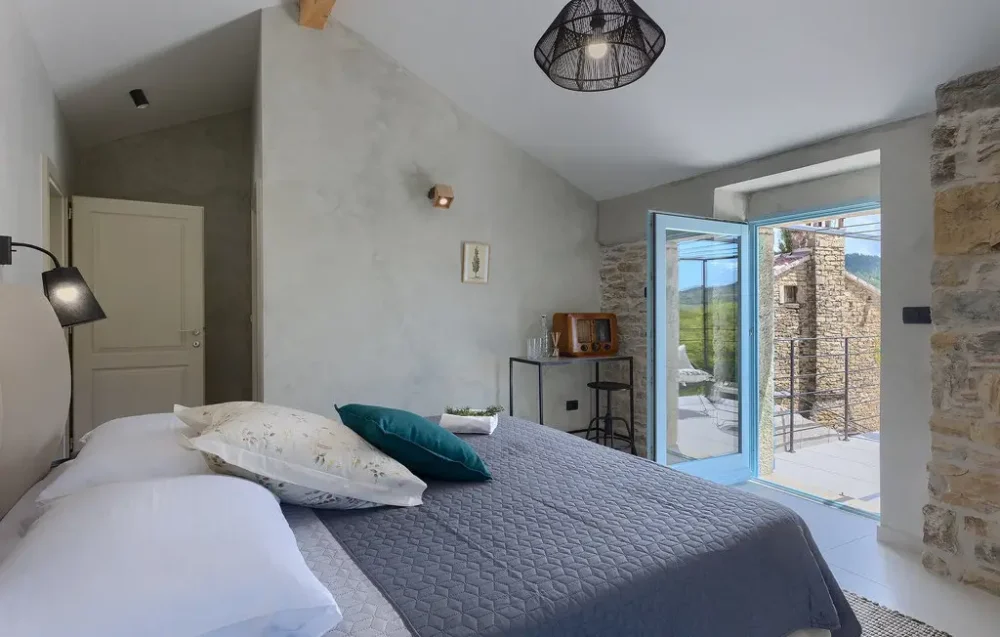 Cozy bedroom with open balcony doors.