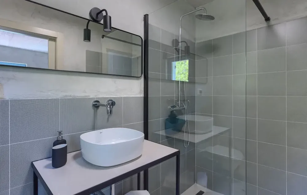 Modern bathroom with sink and glass shower