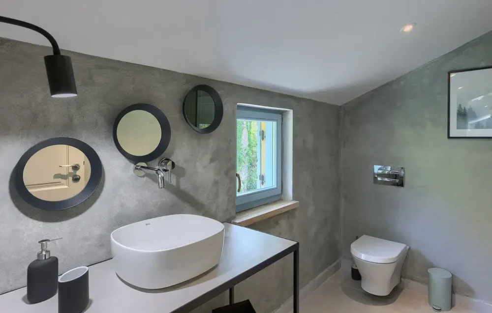 Modern bathroom with mirrors and gray walls