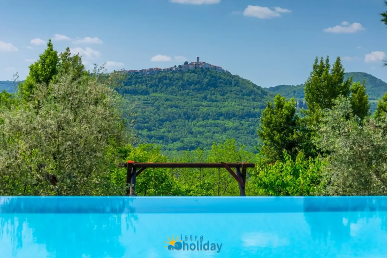 Scenic pool view with green hill panorama.