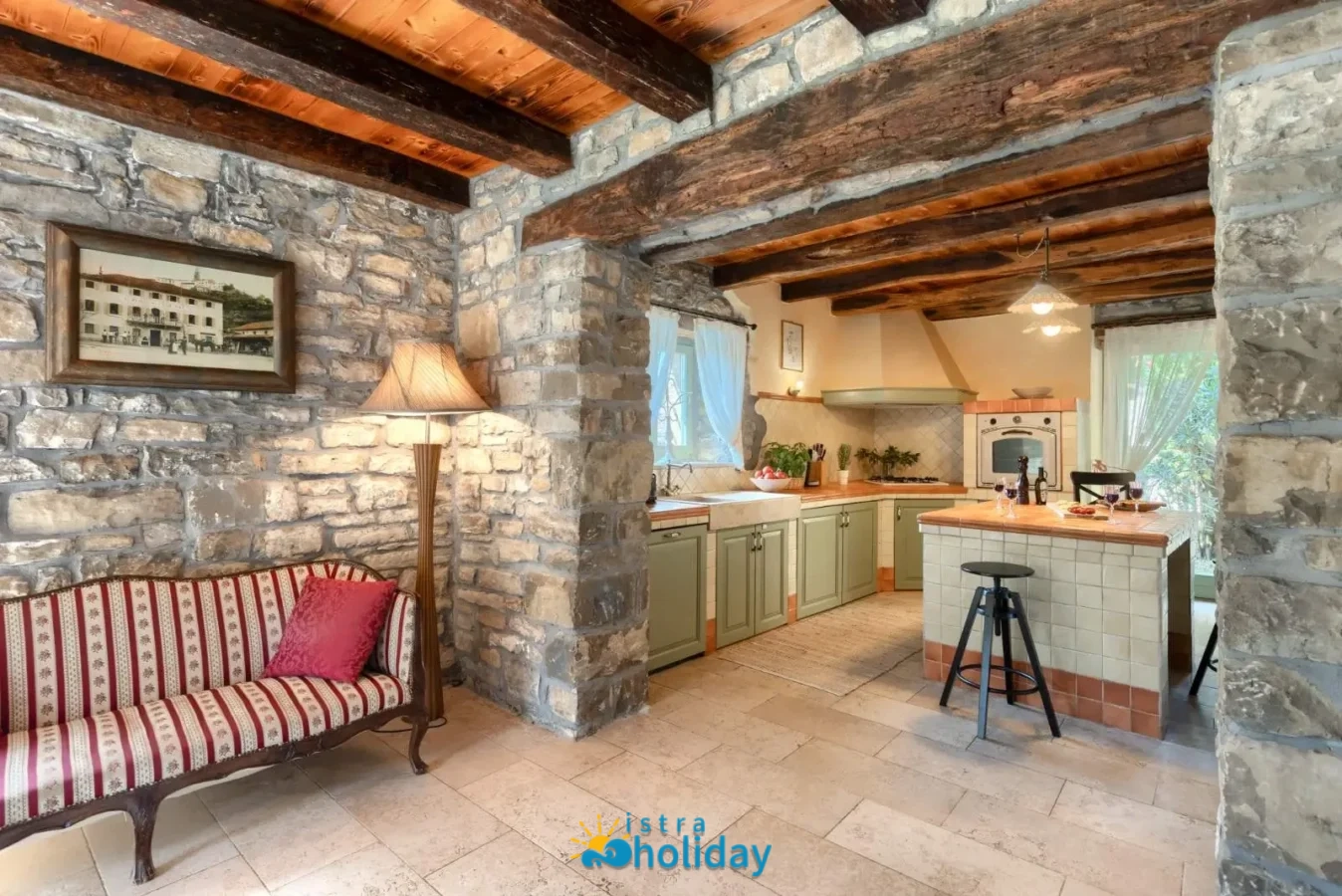 Rustic kitchen with stone walls and wood ceiling.