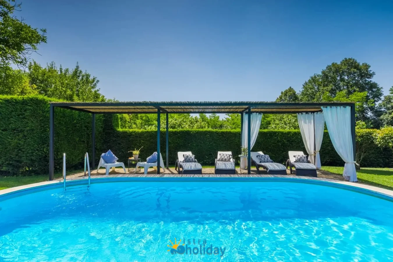 Outdoor pool with lounge chairs and canopy