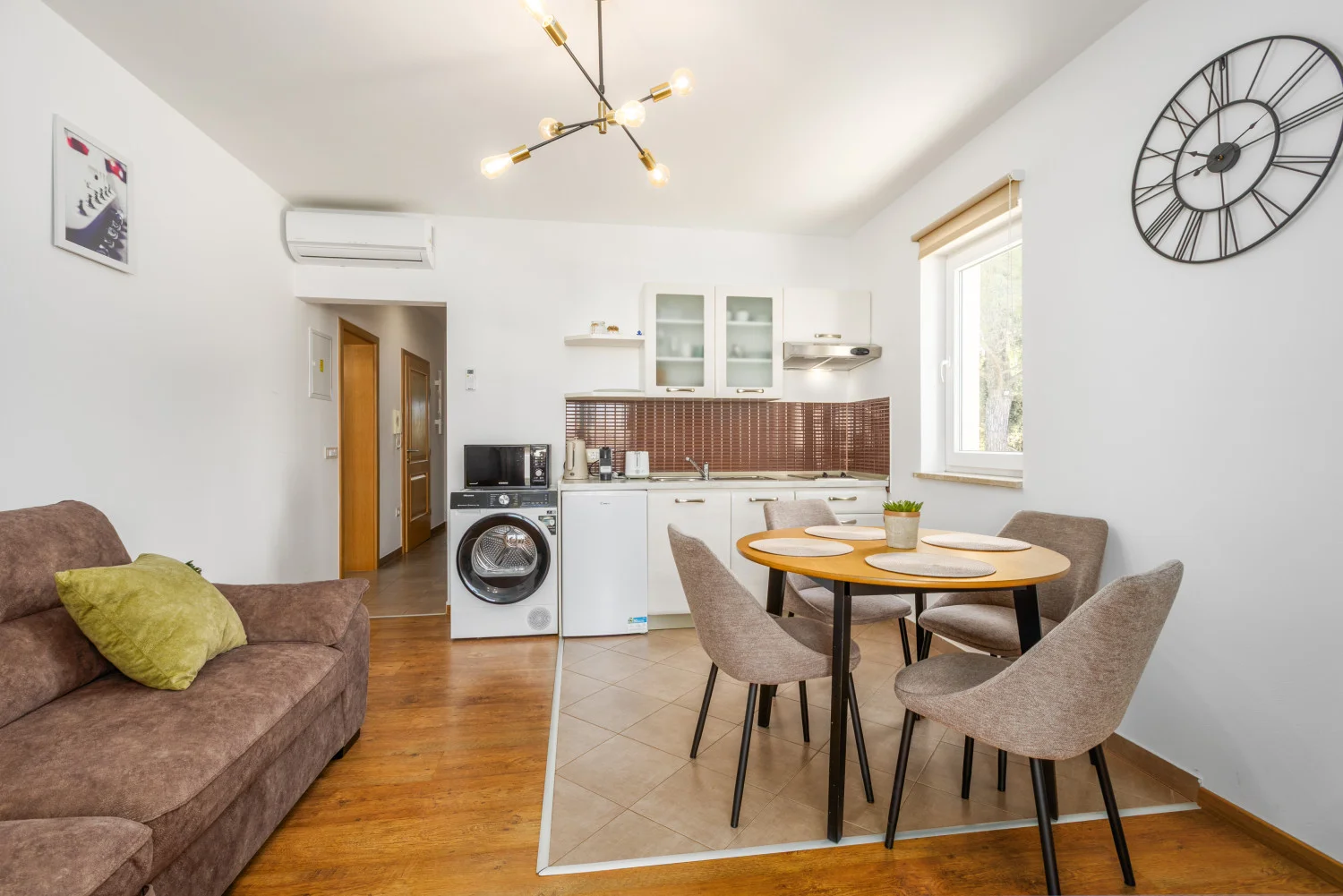 Modern small kitchen and dining area with sofa