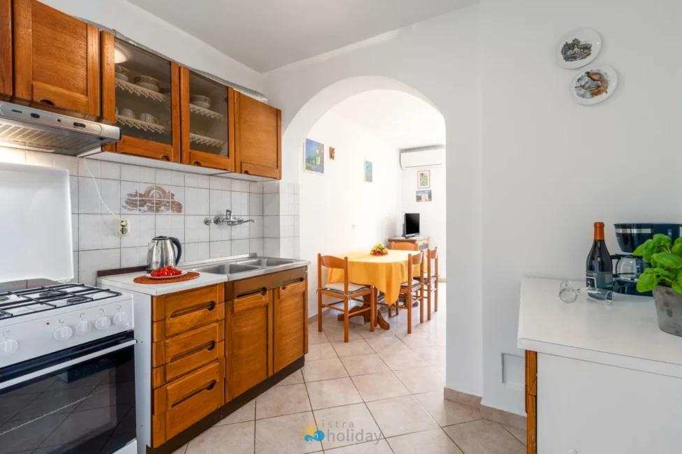 Bright kitchen with wooden cabinets and dining area