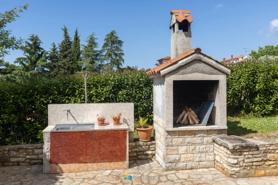 Outdoor stone barbecue grill and garden sink