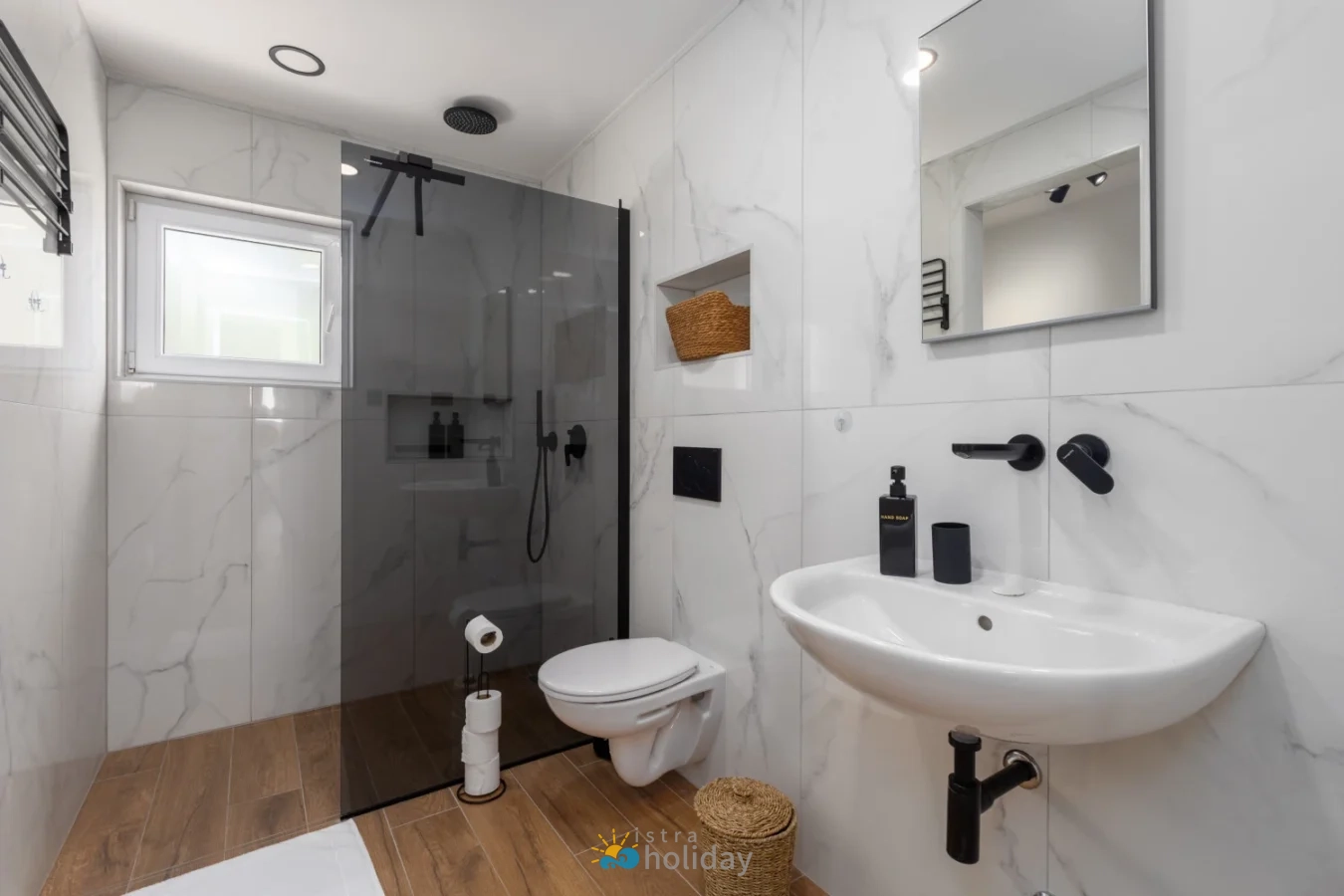 Modern bathroom with glass shower and marble tiles