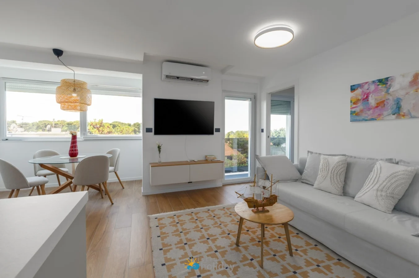 Bright modern living room with dining area and balcony