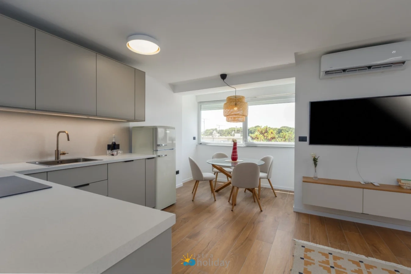 Modern open-plan kitchen and dining area with TV