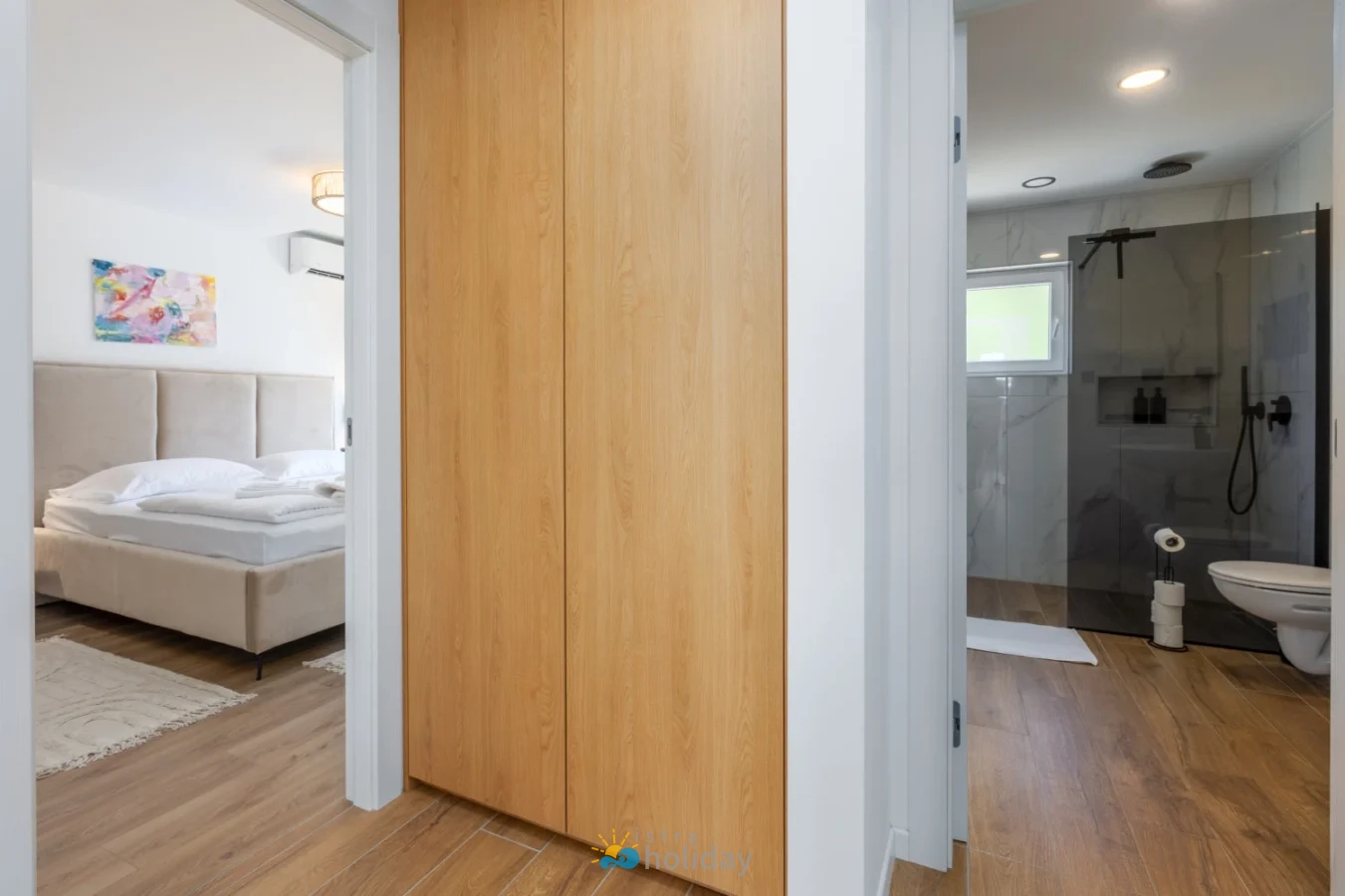 Modern bedroom and bathroom with sliding wooden door