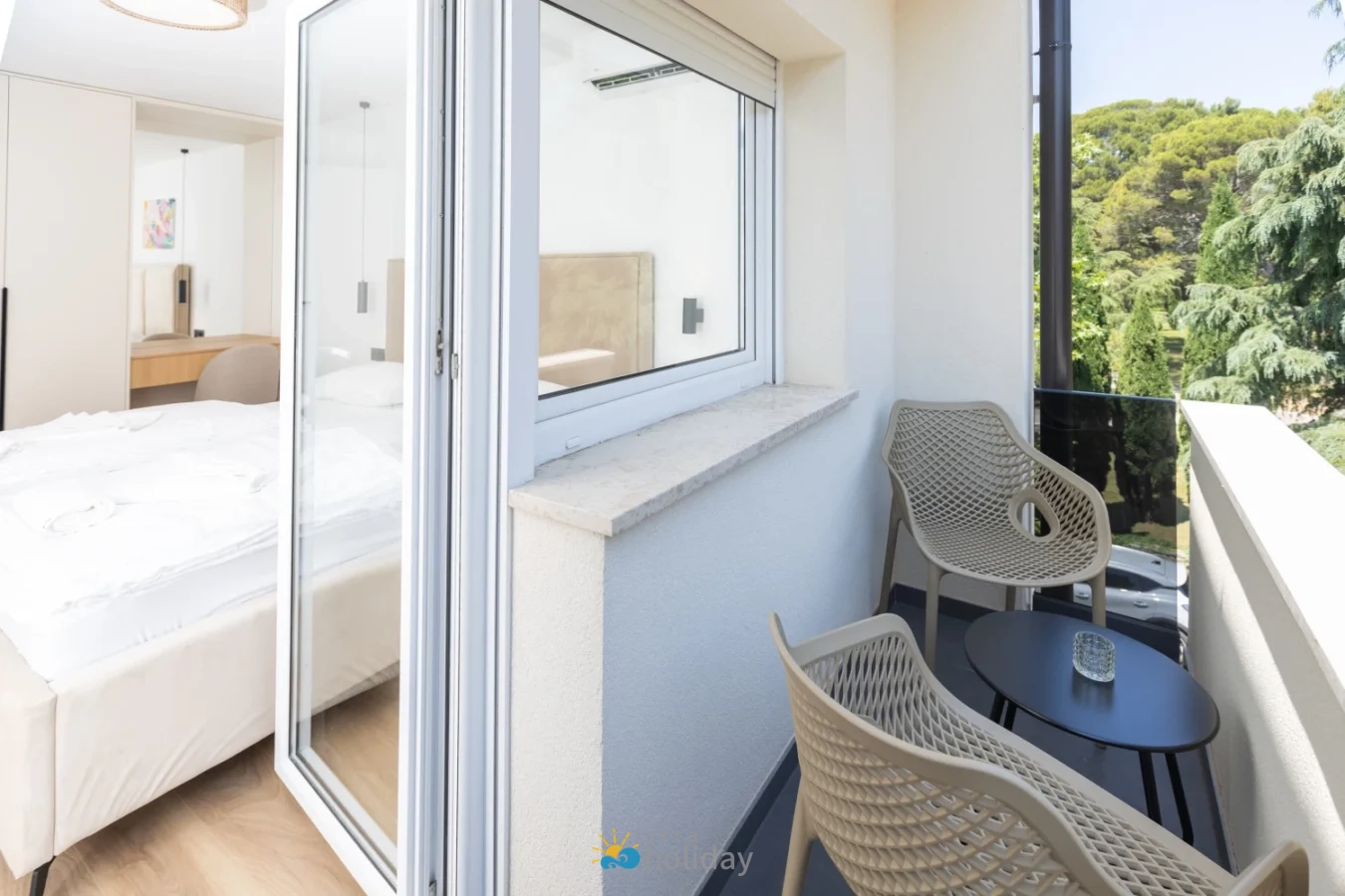 Small modern balcony with chairs and table
