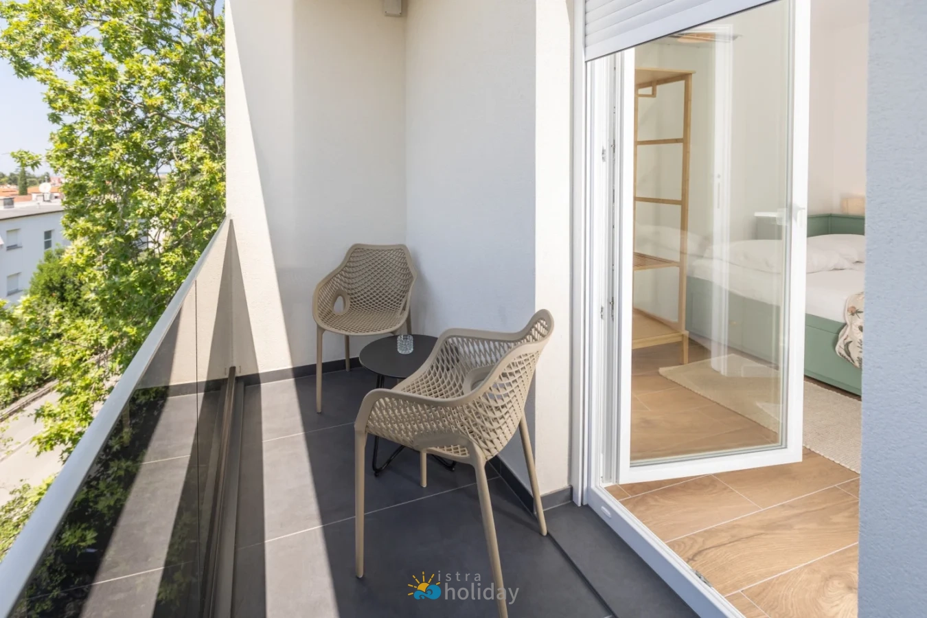 Modern apartment balcony with chairs and small table