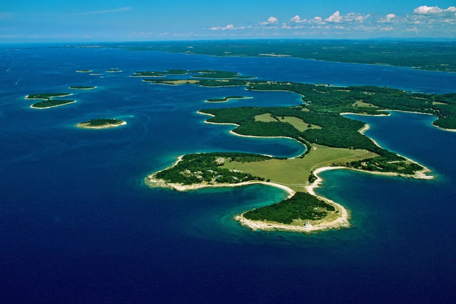 Aerial view of coastal islands with green landscapes.
