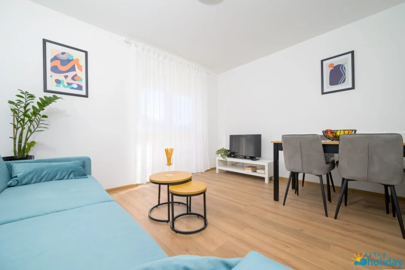 Modern living room with couch and dining area.
