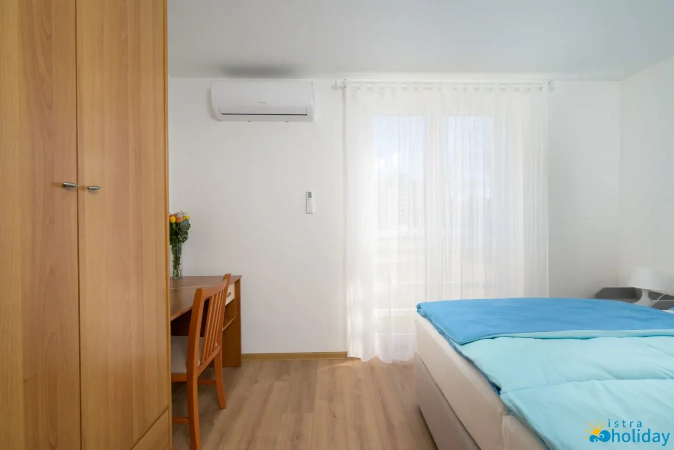 Bright bedroom with desk and wardrobe
