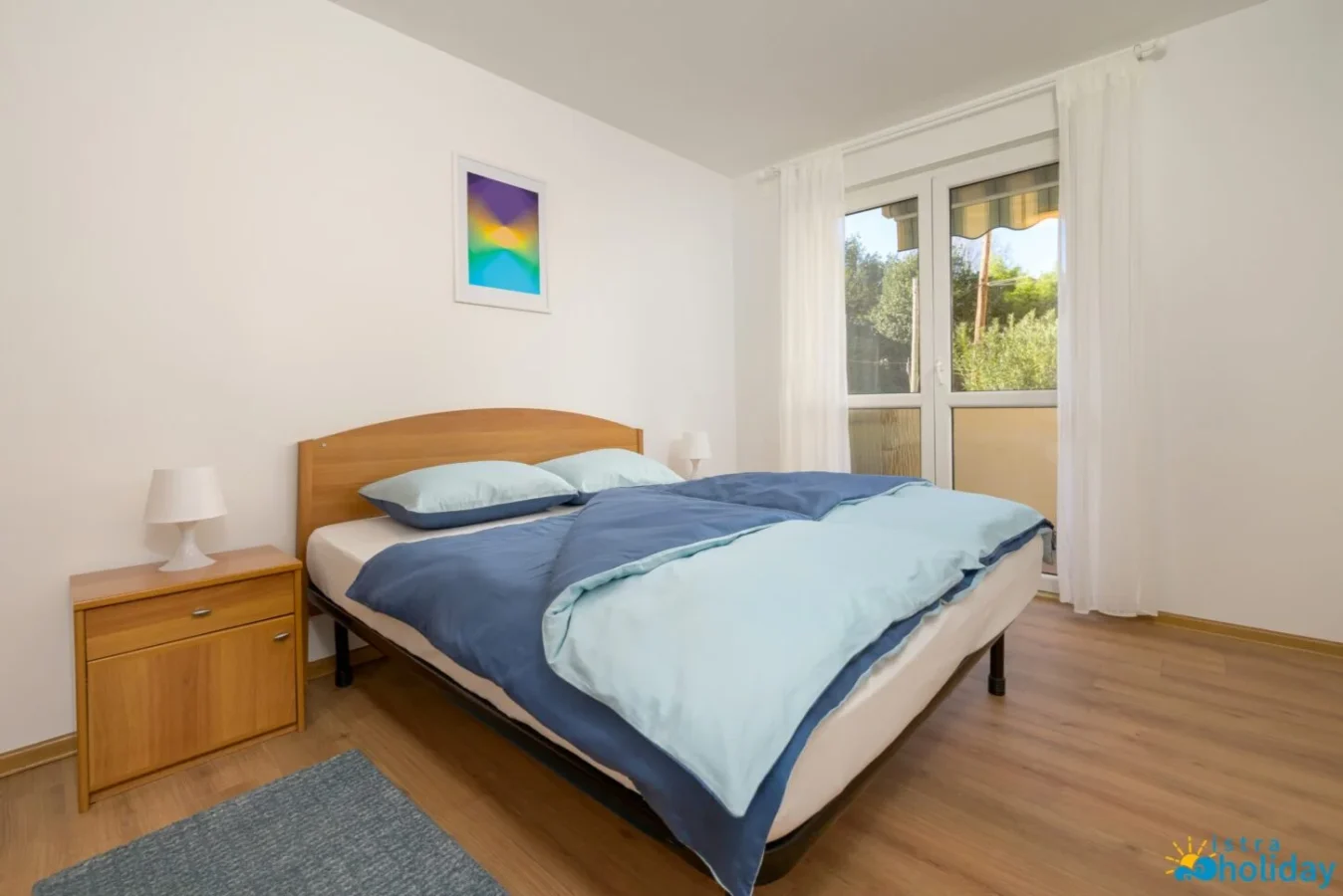 Comfortable bedroom with double bed and window view.