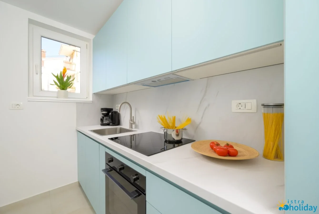 Modern kitchen with blue cabinets and cookware