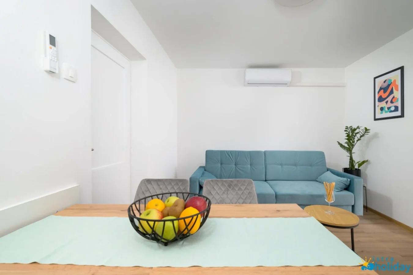 Modern living room with sofa and fruit bowl.