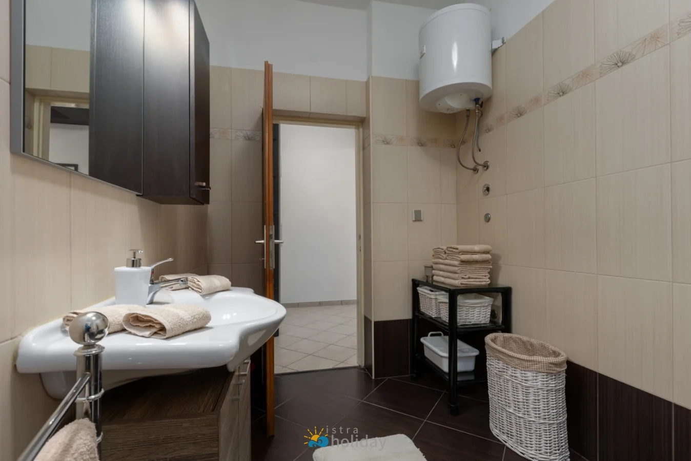 Modern beige bathroom with sink and folded towels