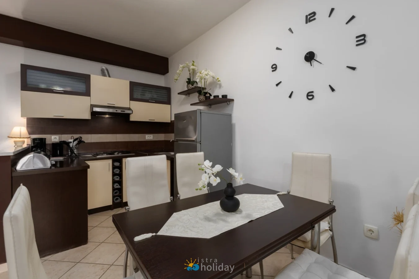 Modern kitchen and dining area with wall clock
