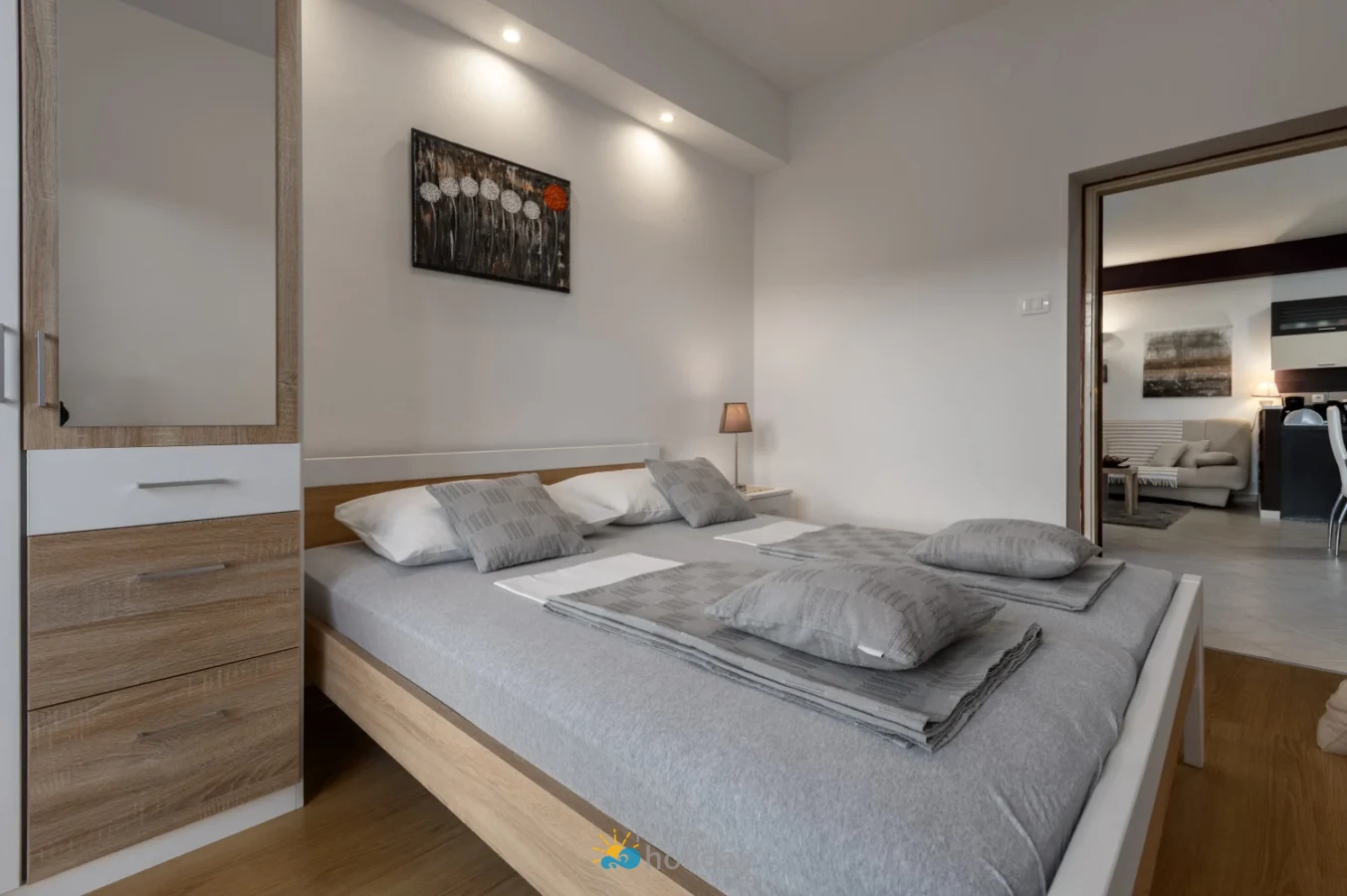 Modern bedroom with gray bedding and wooden furniture