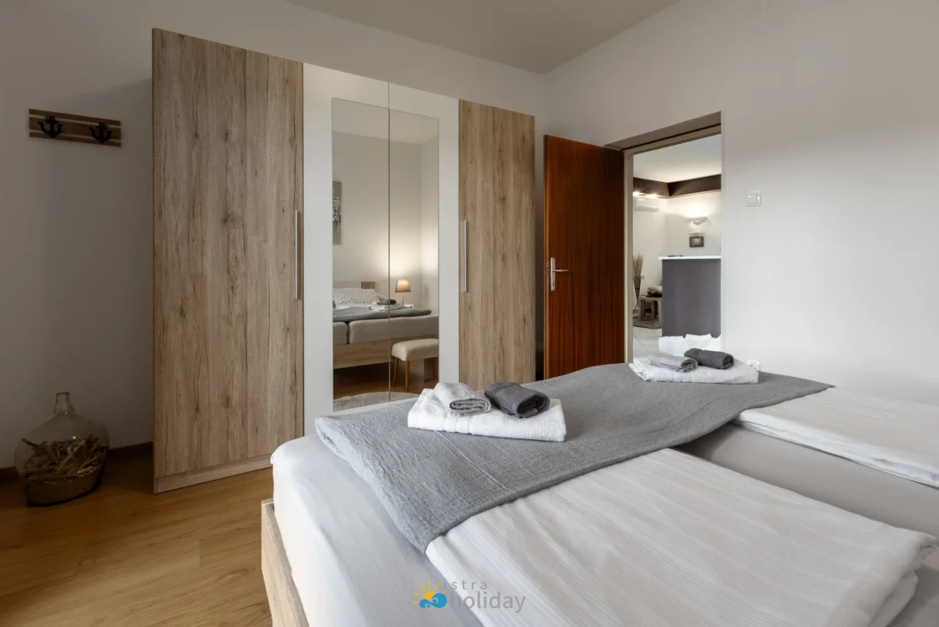 Modern bedroom with twin beds and mirrored wardrobe