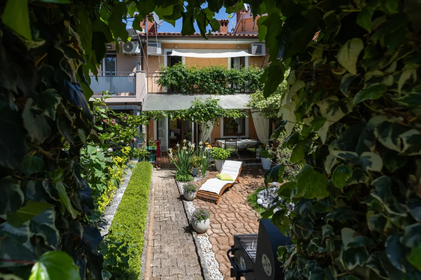 Cozy backyard garden patio with lounge chair