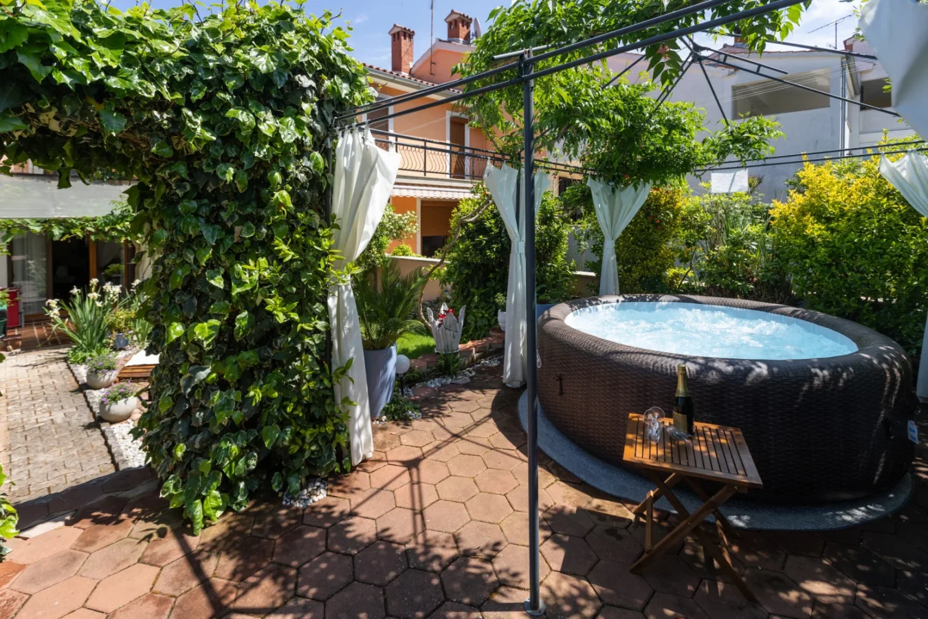 Garden patio with hot tub and canopy