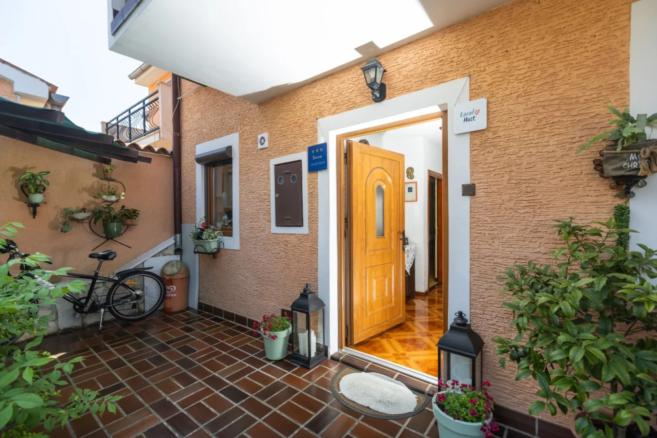 Cozy apartment entrance with plants and bicycle