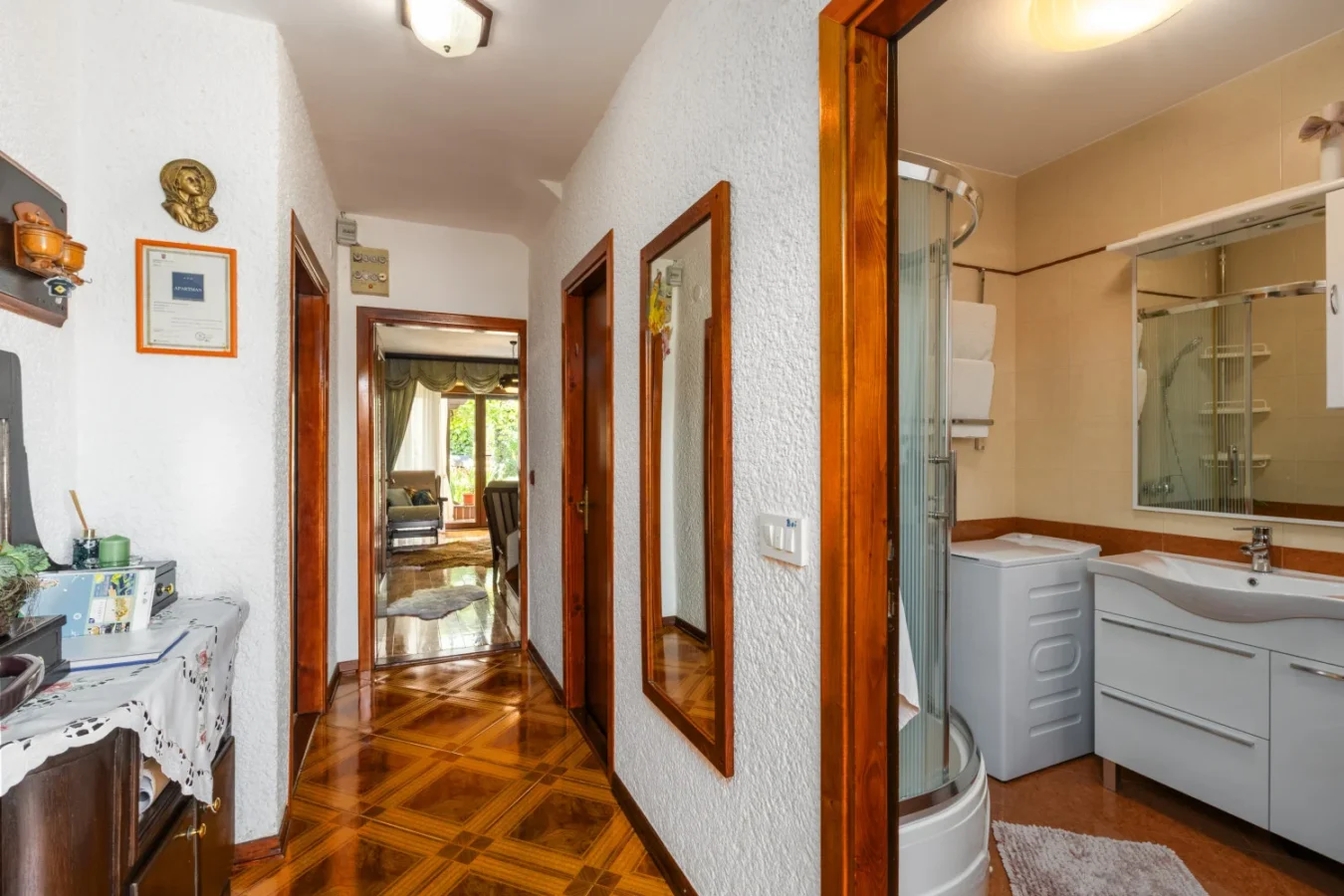 Bright hallway with bathroom and wooden floors