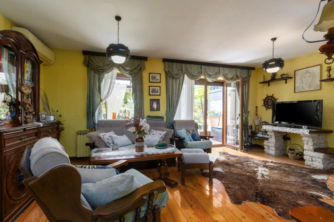 Cozy traditional living room with wooden furniture and balcony