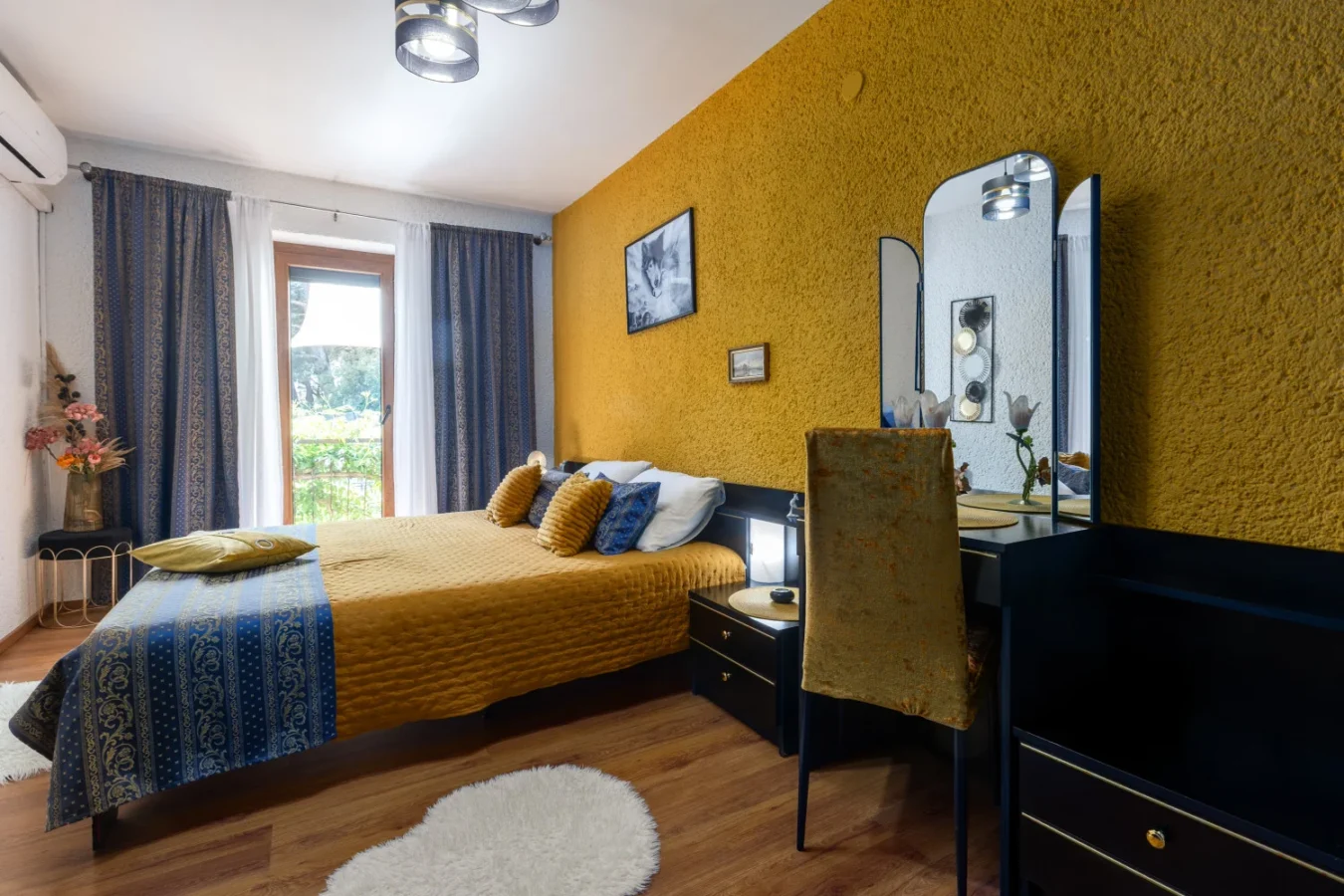 Cozy bedroom with mustard accent wall and vanity