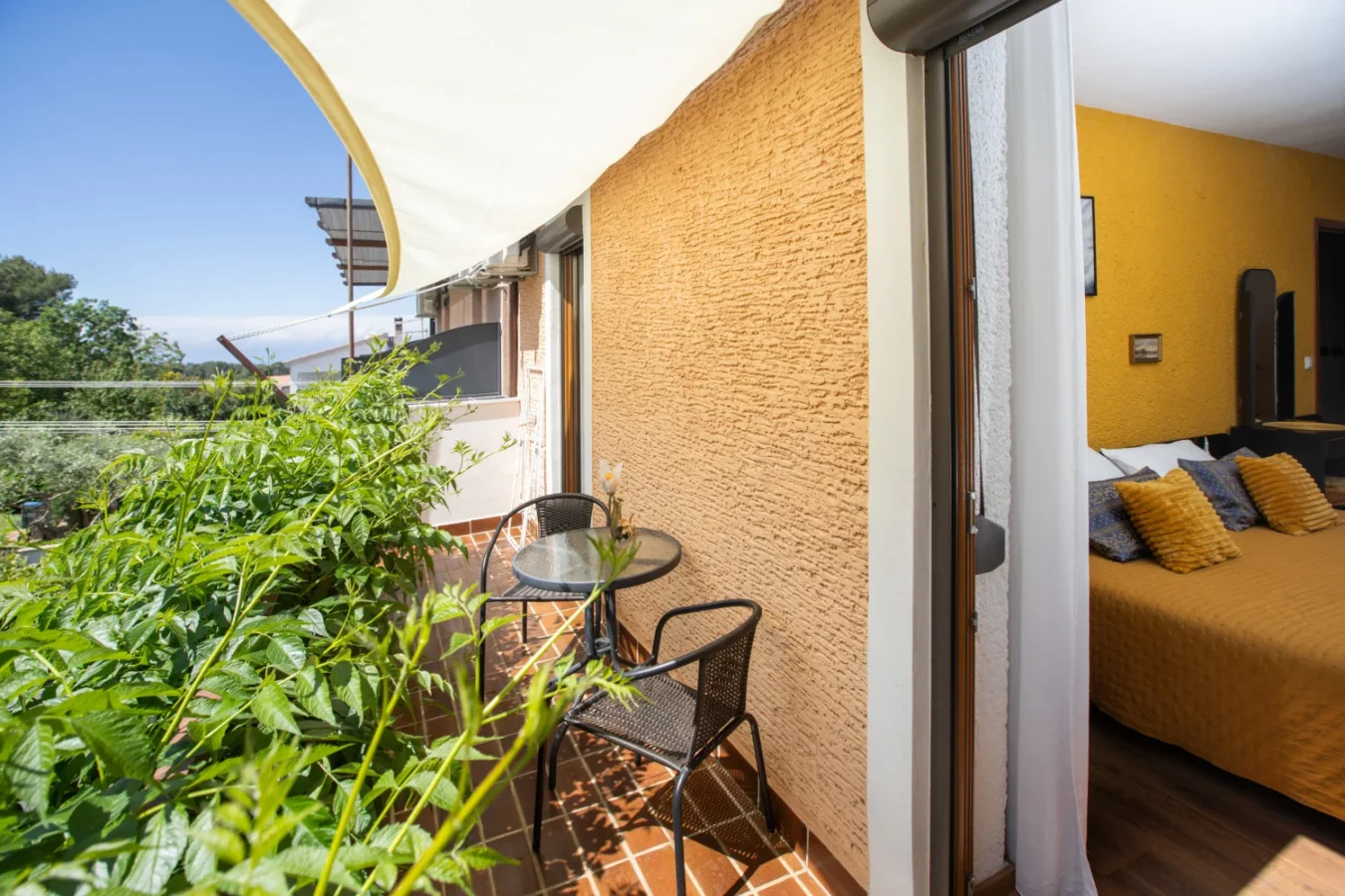 Cozy balcony with table and bedroom view
