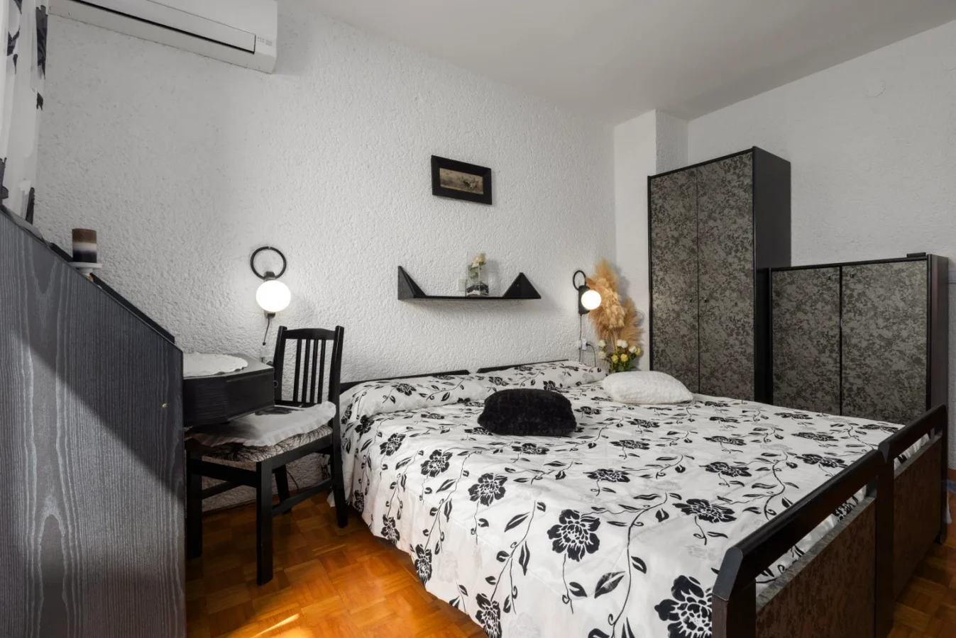 Cozy bedroom with floral bedding and wooden floors