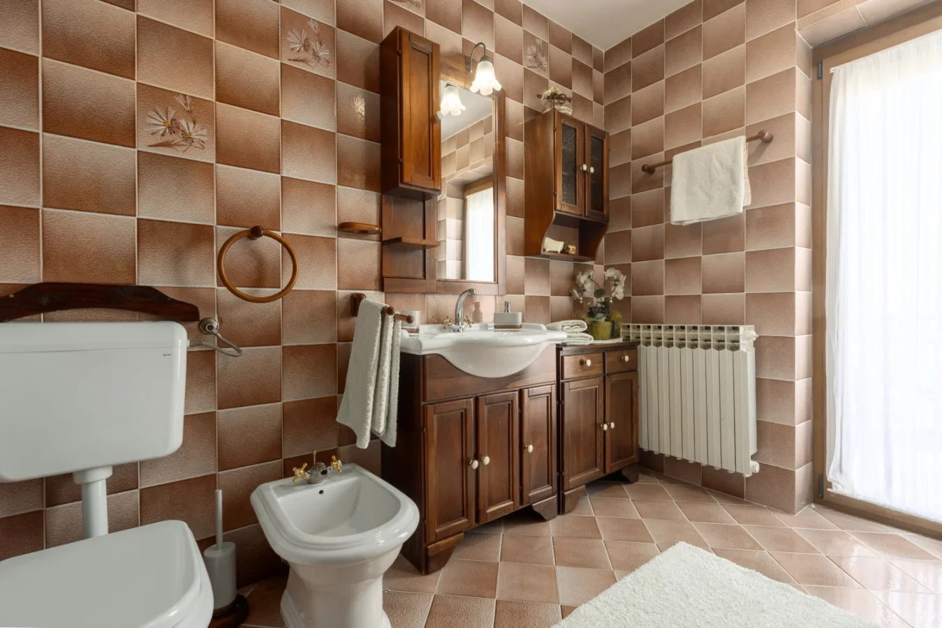 Vintage bathroom with brown tiles and wooden vanity