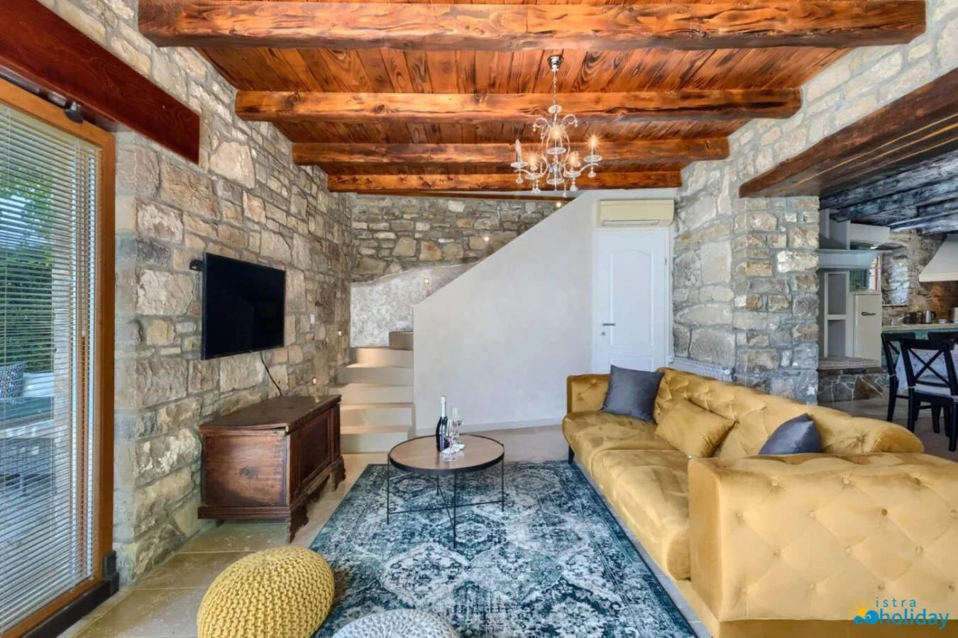 Cozy living room with stone walls and yellow sofa.