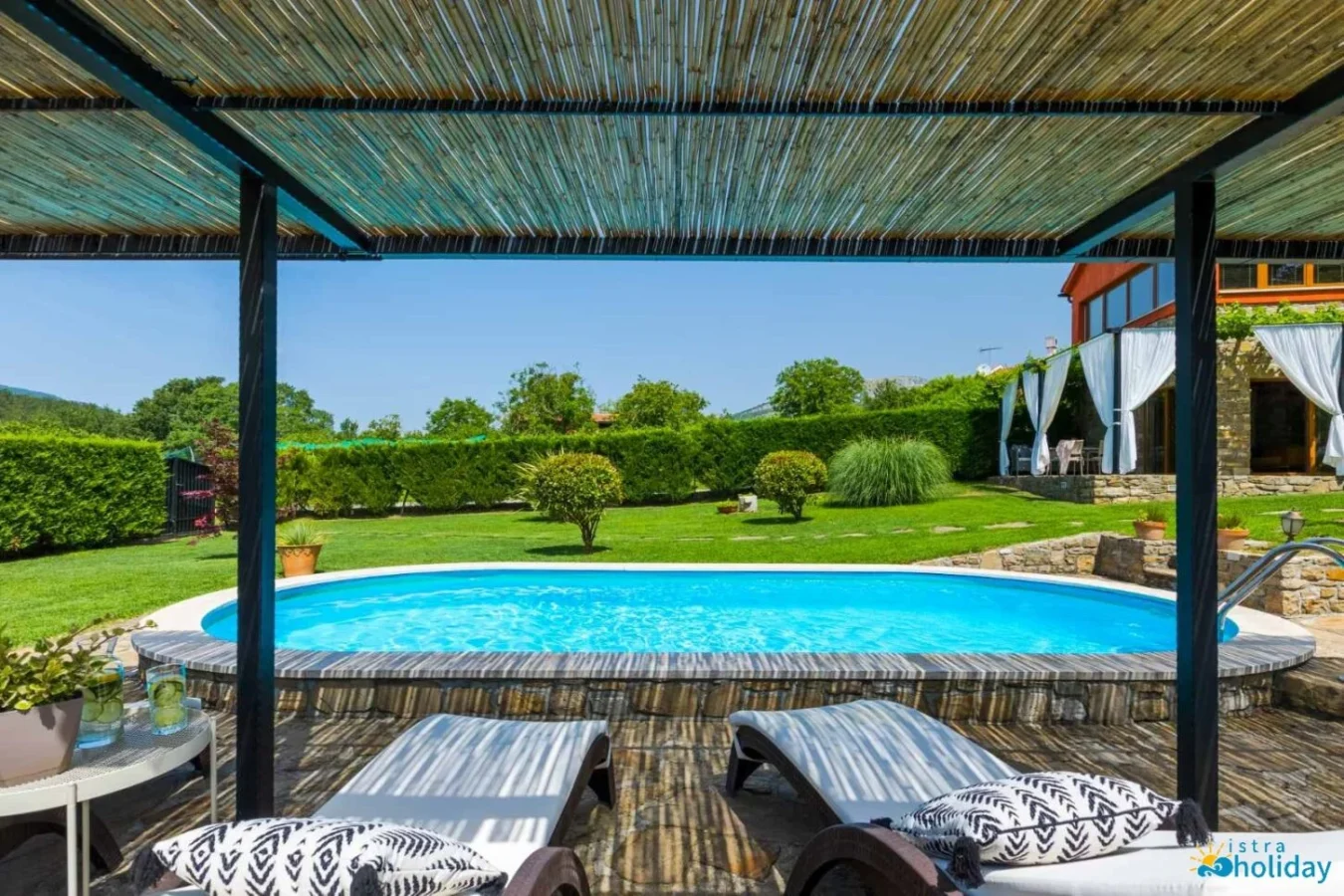 Sunny backyard with swimming pool and lounge chairs.