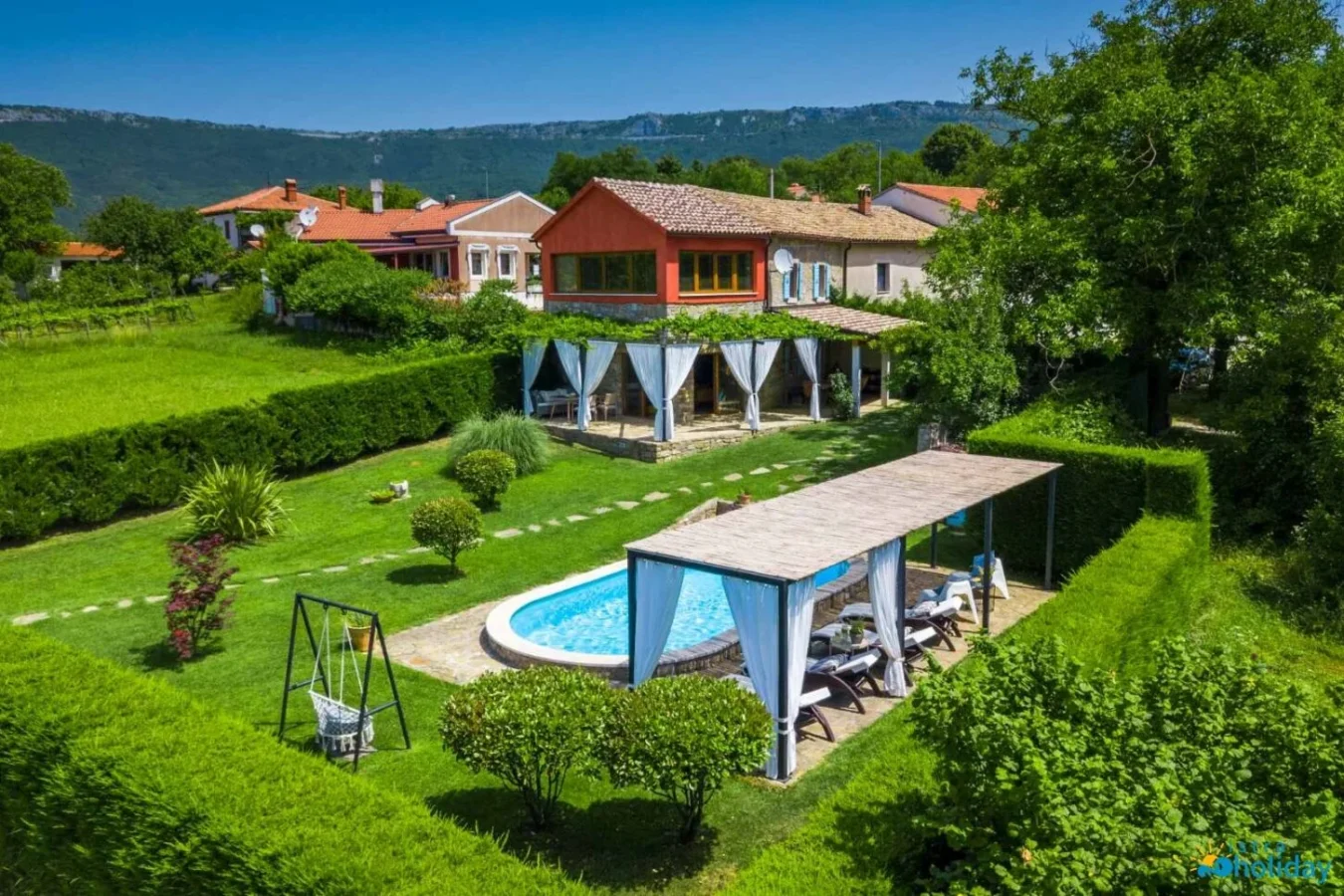 Charming villa with pool and green garden view.