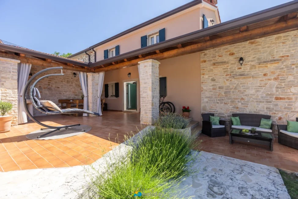 Rustic stone house patio with outdoor seating